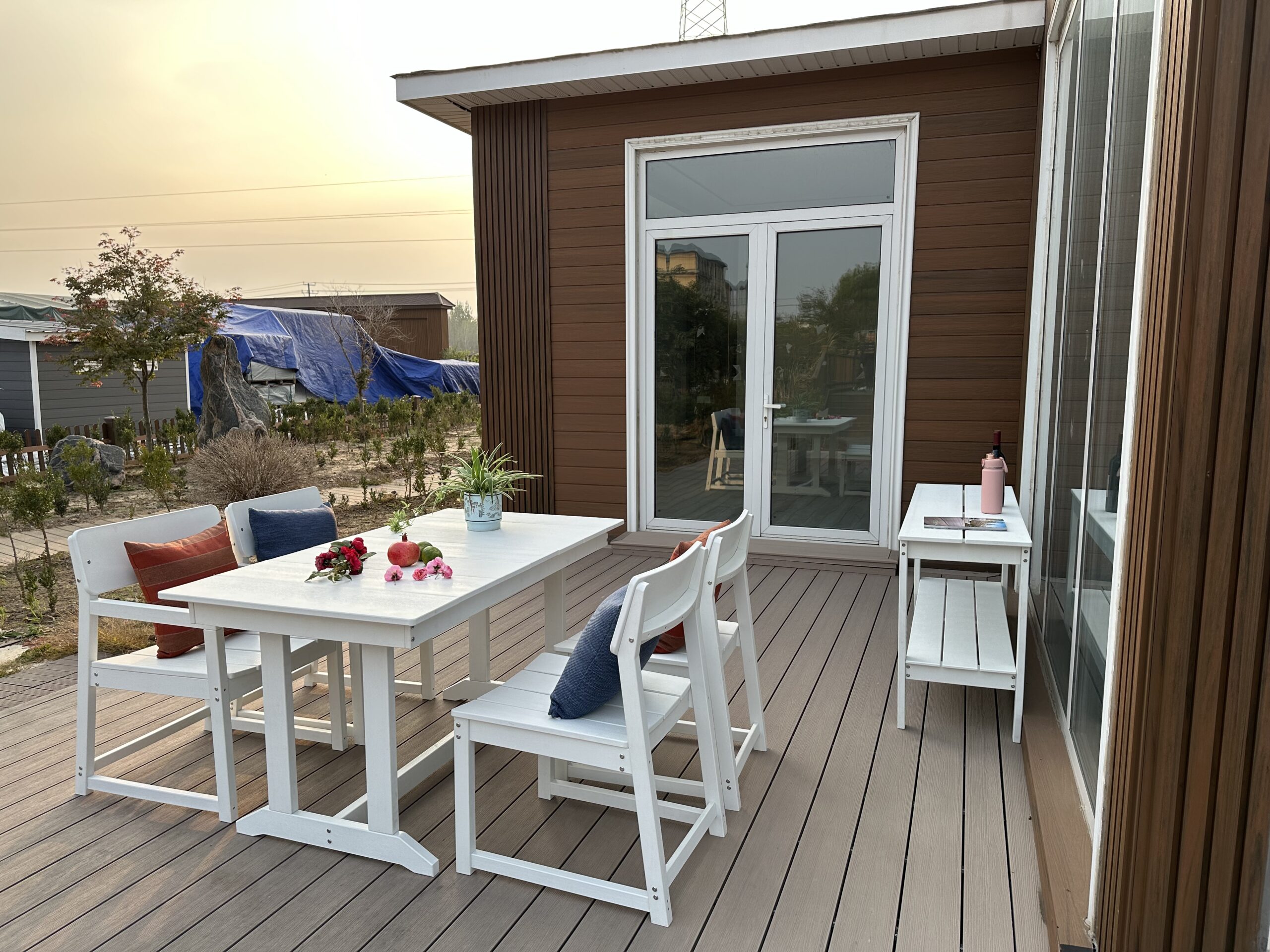 deck with white table and chairs