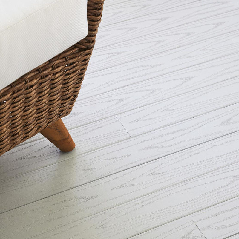 detail of oyster porch boards and a rattan chair.