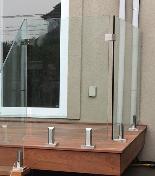 spigots holding glass railing on stairs and deck