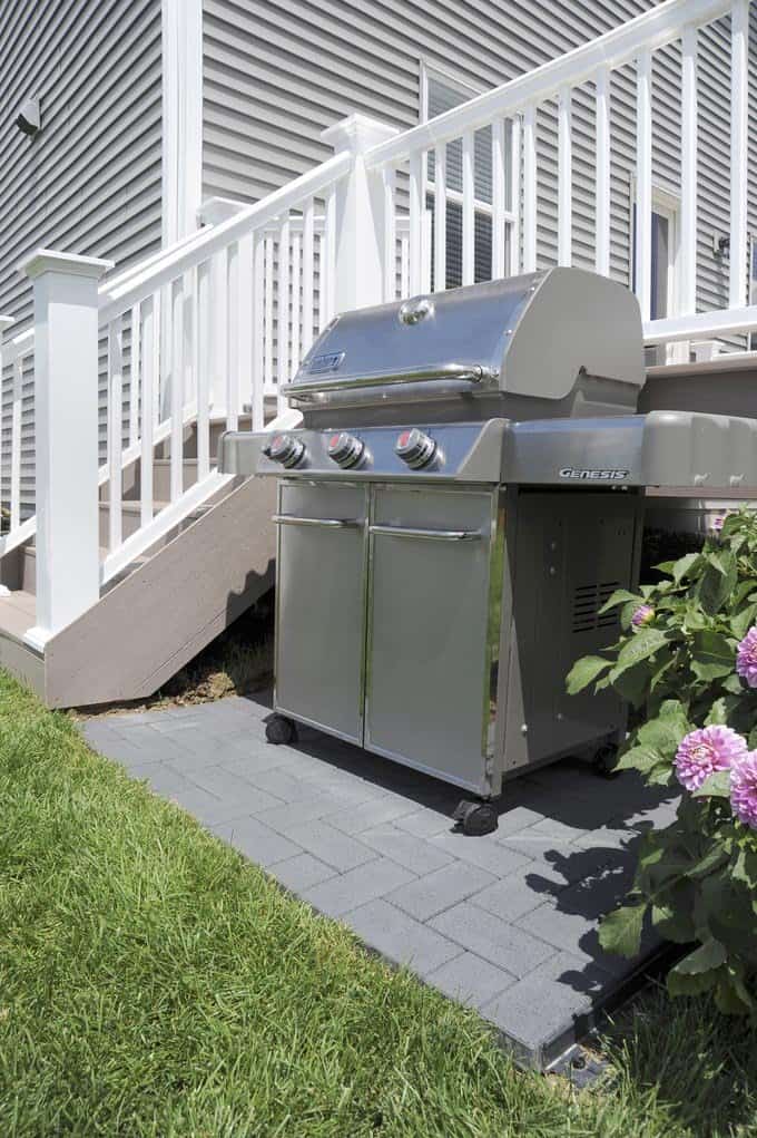side of deck highlighting white rail and a bbq
