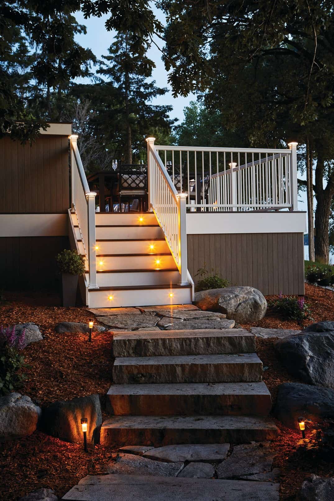 Night shot of walkway leading up to back illuminated deck