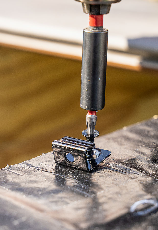 starter clip being screwed into joist