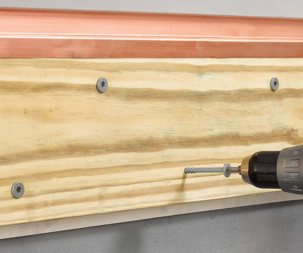 ledgerLOK flat head deck screw inserted into ledger board