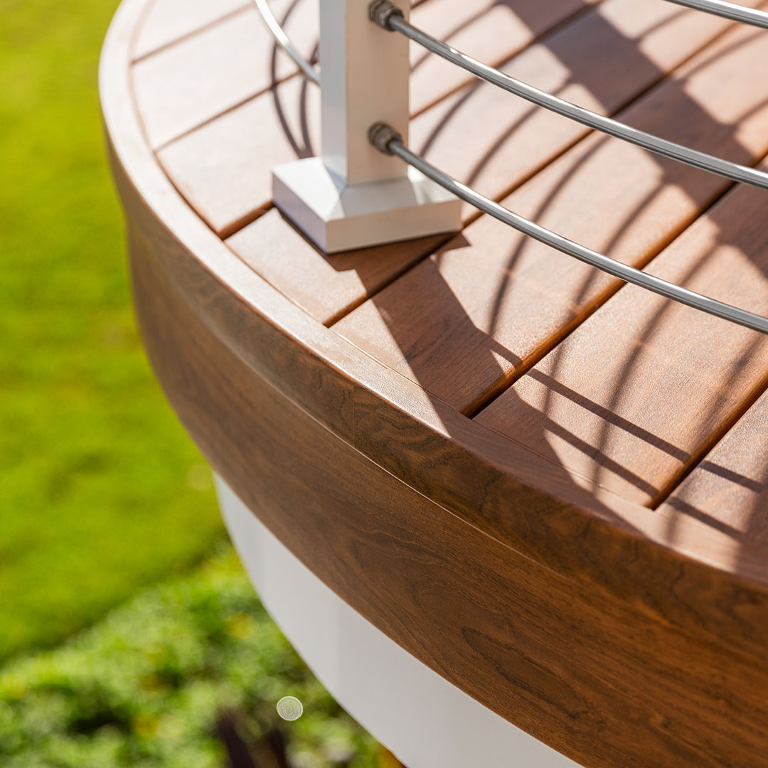 Zuri decking handles curves. Example colour is Walnut